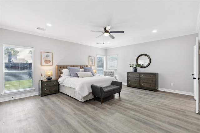 bedroom with crown molding, light wood-style floors, baseboards, recessed lighting, and a ceiling fan