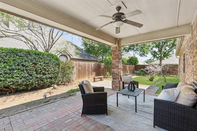 view of patio featuring a fenced backyard, an outdoor living space, and ceiling fan