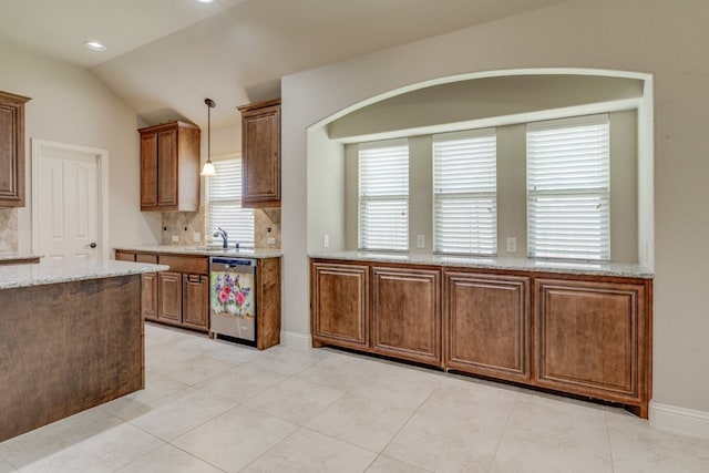 1002 Star Grass Dr, Mansfield, TX 76063 - kitchen with stainless steel dishwasher, tasteful backsplash, lofted ceiling, decorative light fixtures, and light stone countertops
