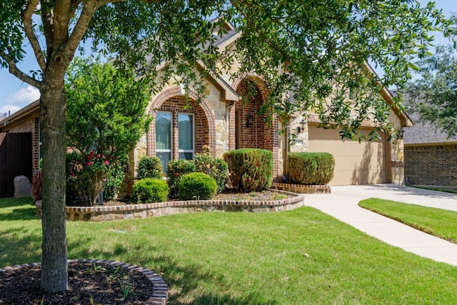 1002 Star Grass Dr, Mansfield, TX 76063 - view of property hidden behind natural elements featuring driveway, brick siding, a front yard, stone siding, and a garage