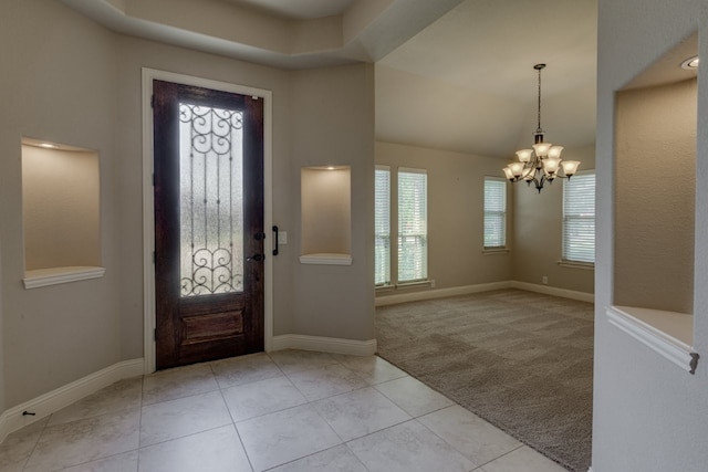 1002 Star Grass Dr, Mansfield, TX 76063 - foyer entrance with a chandelier, light colored carpet, light tile patterned floors, and baseboards