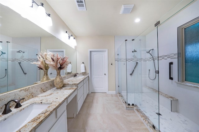 full bath featuring a stall shower, double vanity, and recessed lighting