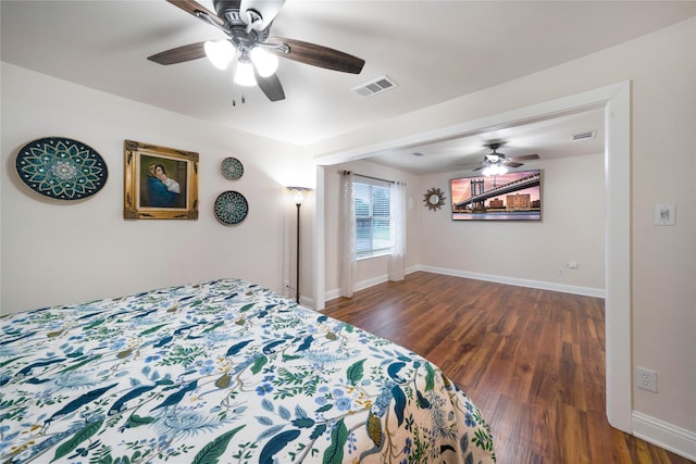 bedroom with dark wood-type flooring, baseboards, and ceiling fan