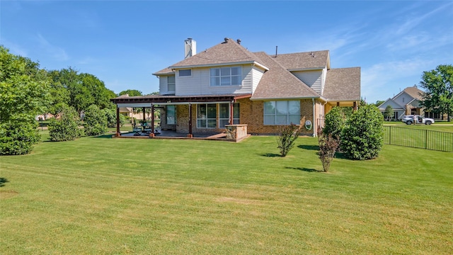 rear view of property featuring brick siding, roof with shingles, and a patio area