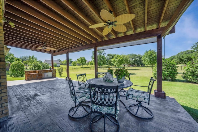 view of patio / terrace with a ceiling fan, outdoor dining area, and a deck