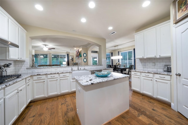 kitchen with backsplash, a sink, white cabinets, a ceiling fan, and recessed lighting