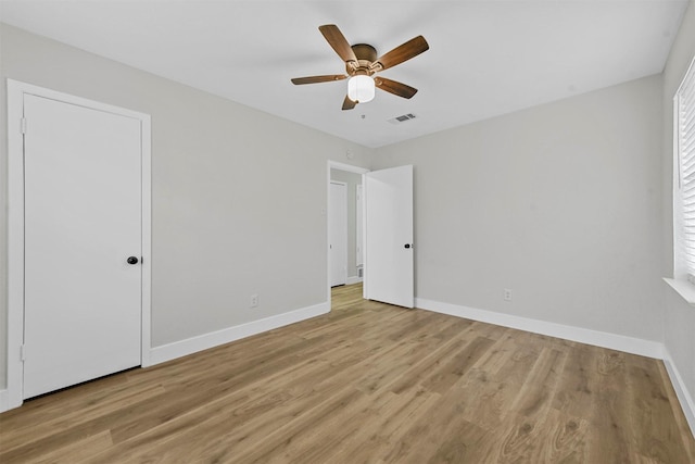 1846 Oak Hill Cir, Dallas, TX 75217 - unfurnished bedroom with baseboards, light wood-type flooring, and ceiling fan