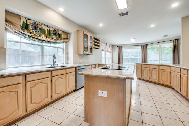 kitchen with light brown cabinetry, a sink, stainless steel dishwasher, and recessed lighting