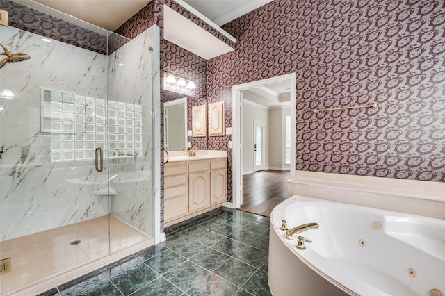 full bathroom with wallpapered walls, a marble finish shower, a whirlpool tub, vanity, and crown molding