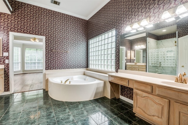 bathroom featuring wallpapered walls, ornamental molding, healthy amount of natural light, a stall shower, and a bath
