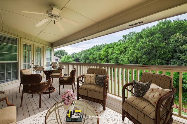 deck featuring an outdoor hangout area, a ceiling fan, and french doors