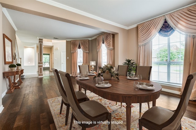 dining room with dark wood-style floors, crown molding, plenty of natural light, ornate columns, and baseboards