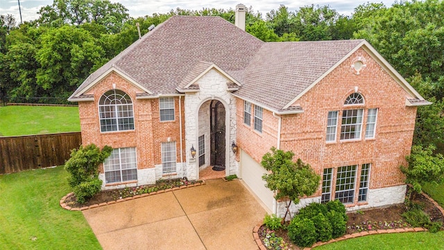 view of front of house with concrete driveway, stone siding, brick siding, and a garage