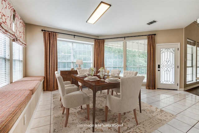 dining space featuring light tile patterned floors and healthy amount of natural light