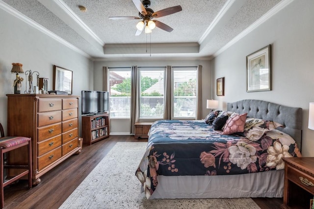 10557 Stargazer Dr, Frisco, TX 75033 - bedroom with a raised ceiling, ornamental molding, dark wood-style flooring, a textured ceiling, and ceiling fan