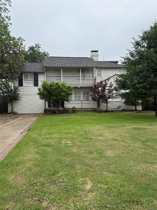 4516 Mockingbird Ln, University Park, TX 75205 - view of front of house featuring a balcony, a front lawn, a chimney, and a shingled roof