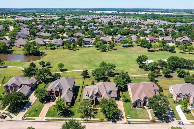 aerial view of residential area featuring a large body of water