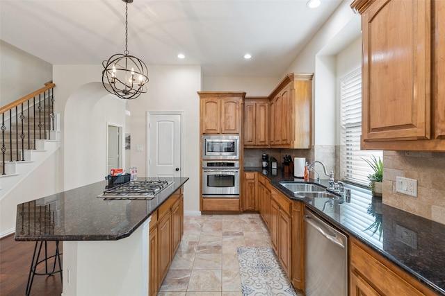 409 Rosemont Ln, Fairview, TX 75069 - kitchen with stainless steel appliances, a sink, dark stone counters, tasteful backsplash, and arched walkways