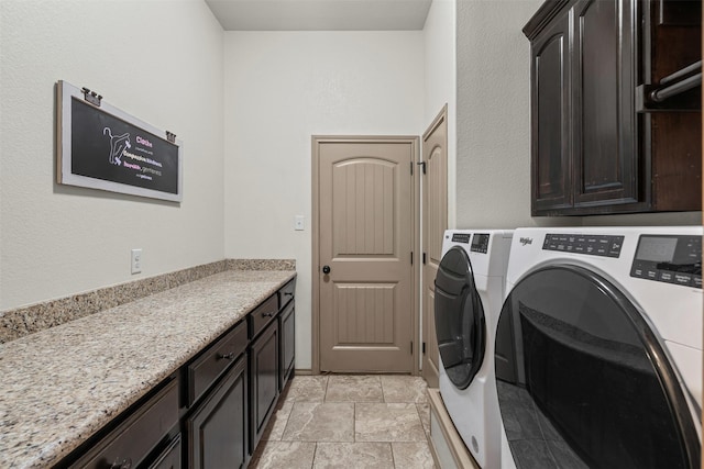 laundry room with washing machine and clothes dryer and cabinet space