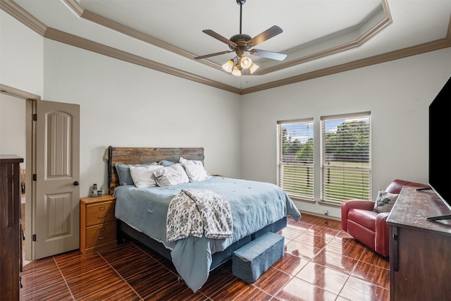 bedroom with a tray ceiling, ornamental molding, and a ceiling fan