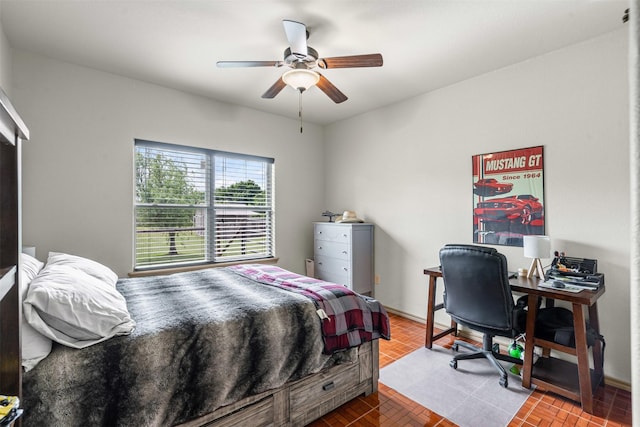 bedroom featuring an office area and ceiling fan