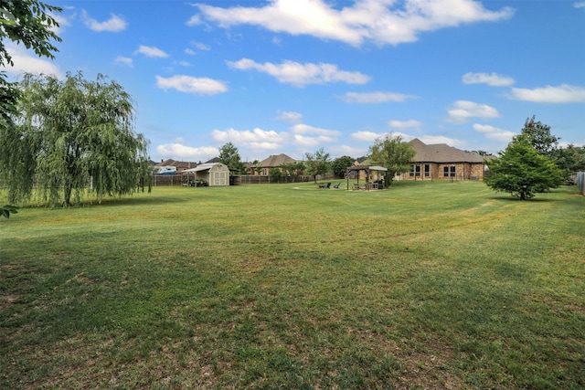 view of yard featuring an outbuilding and a storage shed