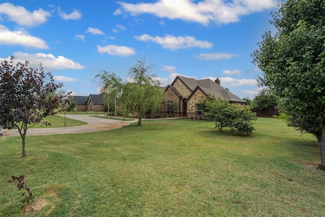 view of front of home featuring stone siding and a front lawn