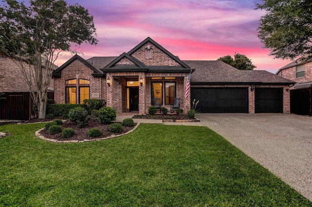 5250 Pueblo Ln, Frisco, TX 75034 - french country style house featuring brick siding, an attached garage, a shingled roof, and concrete driveway