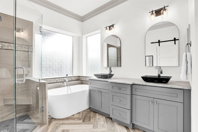 5250 Pueblo Ln, Frisco, TX 75034 - bathroom featuring healthy amount of natural light, a shower stall, double vanity, ornamental molding, and a soaking tub
