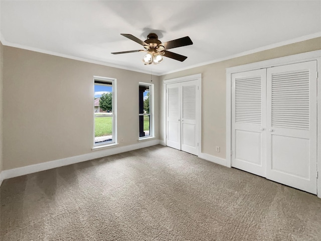8 Woodmoor Cir, Lucas, TX 75002 - unfurnished bedroom with two closets, crown molding, carpet, baseboards, and a ceiling fan