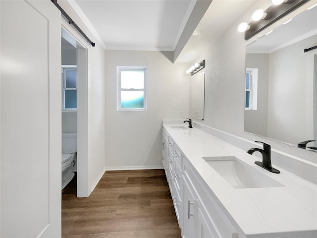 8 Woodmoor Cir, Lucas, TX 75002 - bathroom with crown molding, wood finished floors, toilet, double vanity, and baseboards