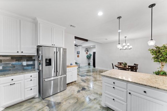 555 Advance Rd, Weatherford, TX 76088 - kitchen with stainless steel fridge, backsplash, finished concrete floors, white cabinets, and baseboards