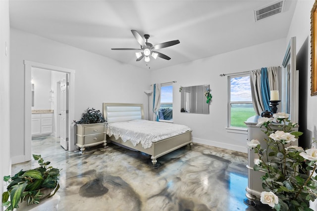 555 Advance Rd, Weatherford, TX 76088 - bedroom with multiple windows, baseboards, ensuite bathroom, and finished concrete flooring