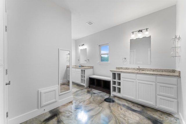 555 Advance Rd, Weatherford, TX 76088 - full bath with two vanities, finished concrete flooring, and baseboards