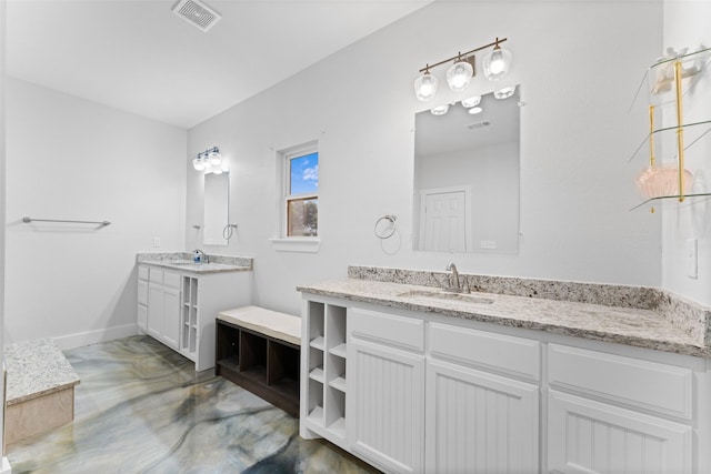 555 Advance Rd, Weatherford, TX 76088 - bathroom with concrete floors, two vanities, and baseboards
