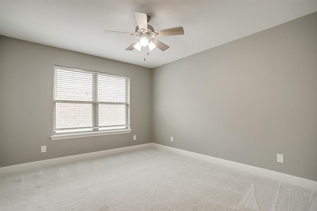unfurnished room with light carpet, baseboards, and ceiling fan