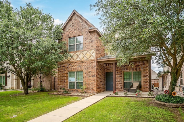 tudor house with brick siding and a front yard