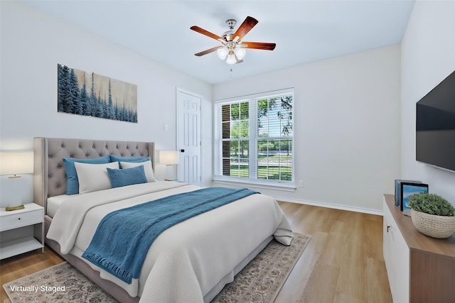 609 W Windsor Dr, Denton, TX 76207 - bedroom with light wood-type flooring, baseboards, and a ceiling fan