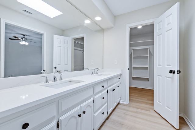 609 W Windsor Dr, Denton, TX 76207 - bathroom with double vanity, wood finished floors, recessed lighting, and baseboards