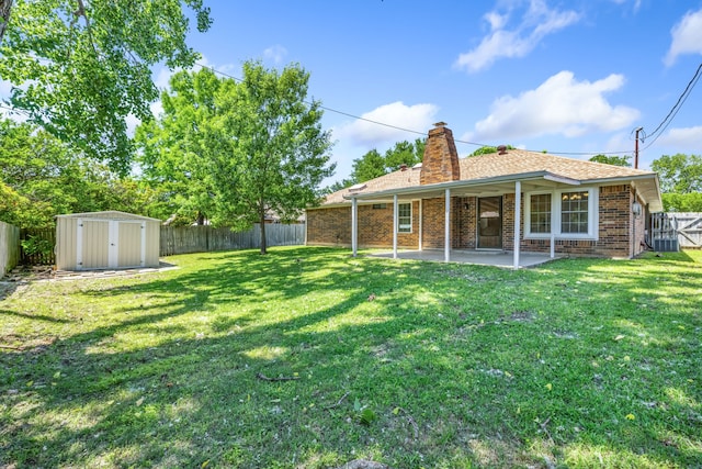 609 W Windsor Dr, Denton, TX 76207 - rear view of house featuring a chimney, a patio, a storage unit, brick siding, and an outdoor structure