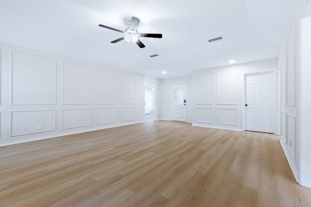 609 W Windsor Dr, Denton, TX 76207 - unfurnished living room featuring a decorative wall, light wood-style flooring, a ceiling fan, and recessed lighting