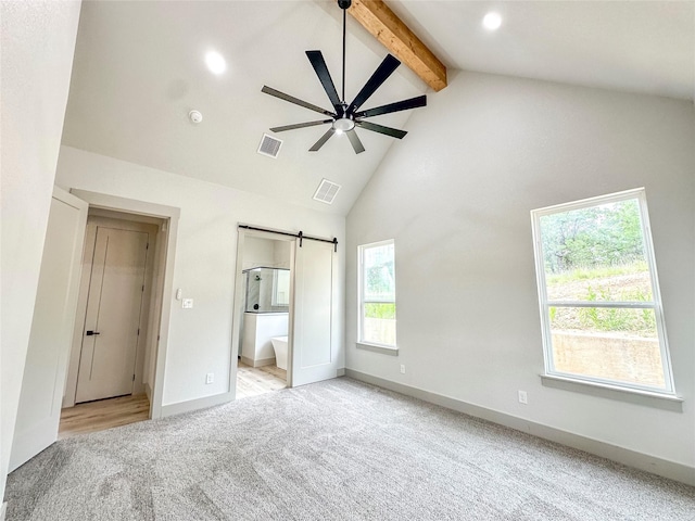 196 Jim Walter Dr, Runaway Bay, TX 76426 - unfurnished bedroom with light colored carpet, beamed ceiling, a barn door, high vaulted ceiling, and baseboards