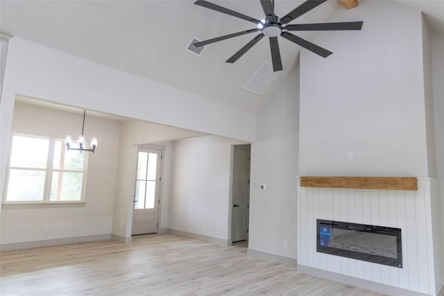 196 Jim Walter Dr, Runaway Bay, TX 76426 - unfurnished living room featuring a glass covered fireplace, wood finished floors, a chandelier, a ceiling fan, and high vaulted ceiling