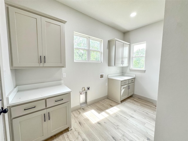 196 Jim Walter Dr, Runaway Bay, TX 76426 - clothes washing area with cabinet space, washer hookup, light wood-type flooring, baseboards, and recessed lighting