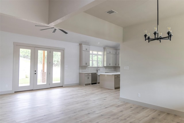 196 Jim Walter Dr, Runaway Bay, TX 76426 - unfurnished living room featuring light wood finished floors, a chandelier, baseboards, and a sink