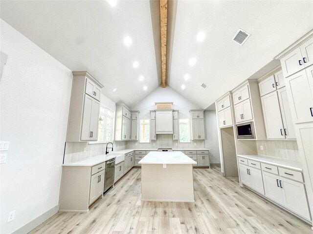 196 Jim Walter Dr, Runaway Bay, TX 76426 - kitchen with appliances with stainless steel finishes, a center island, backsplash, light wood-style flooring, and a sink