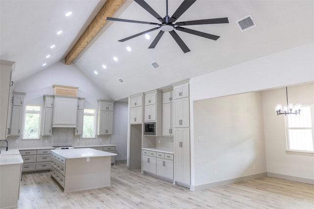 196 Jim Walter Dr, Runaway Bay, TX 76426 - kitchen with gray cabinets, beamed ceiling, a center island, light wood-style floors, and ceiling fan