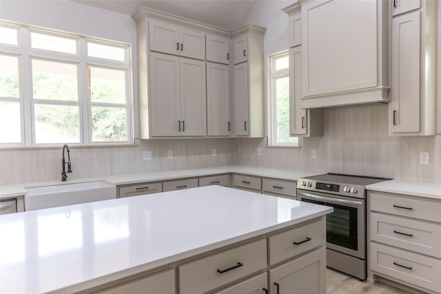 196 Jim Walter Dr, Runaway Bay, TX 76426 - kitchen featuring electric stove, a sink, decorative backsplash, light countertops, and light wood-style floors