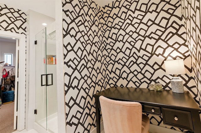 bathroom featuring wallpapered walls and a shower stall