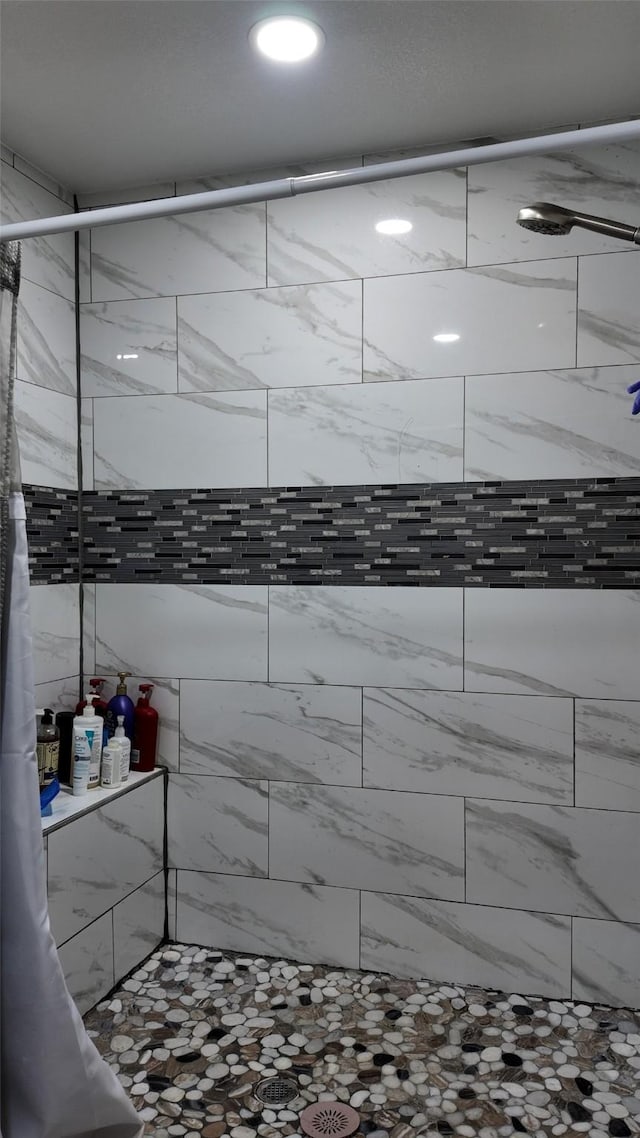 bathroom with a tile shower
